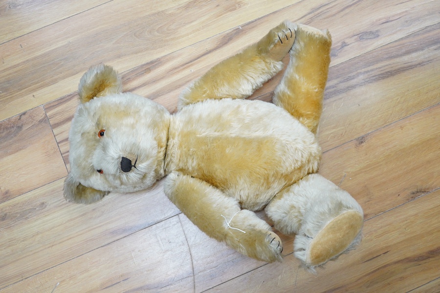 A gold plush mohair teddy bear, perhaps Chad Valley, circa 1950, approx 62cm tall. Condition - fair to good.
